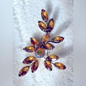 Vintage amber rhinestone spray brooch with AB center stone.